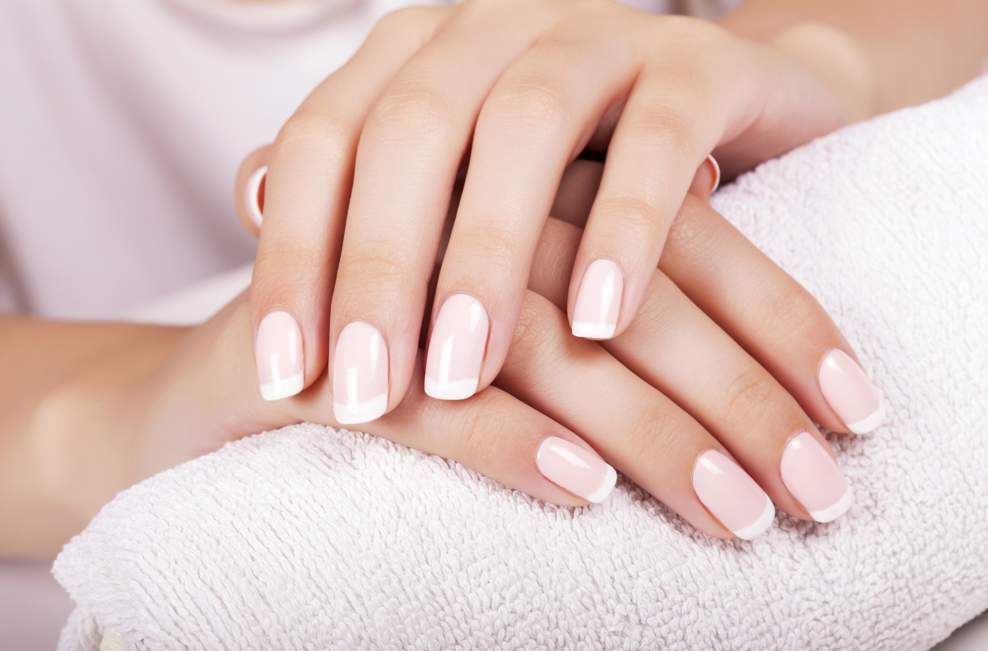 Beautiful woman’s nails with french manicure.